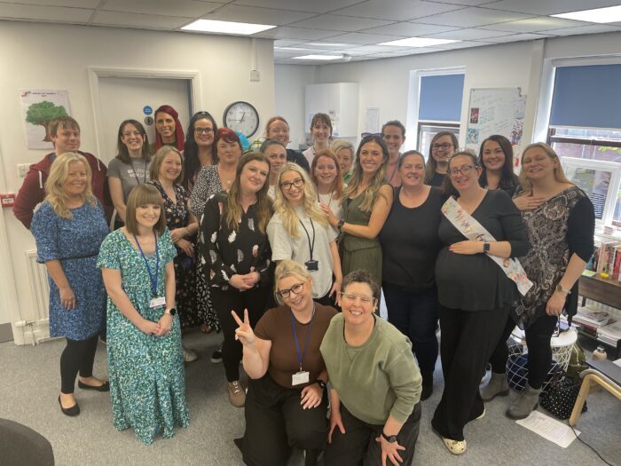 smiling female team members in office of Compass Be