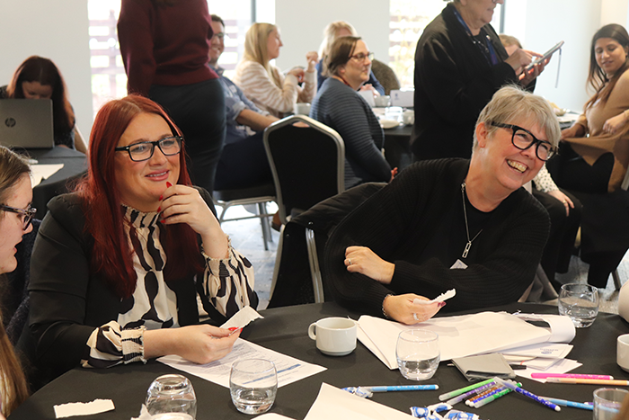 compass induction two women atfaff at table