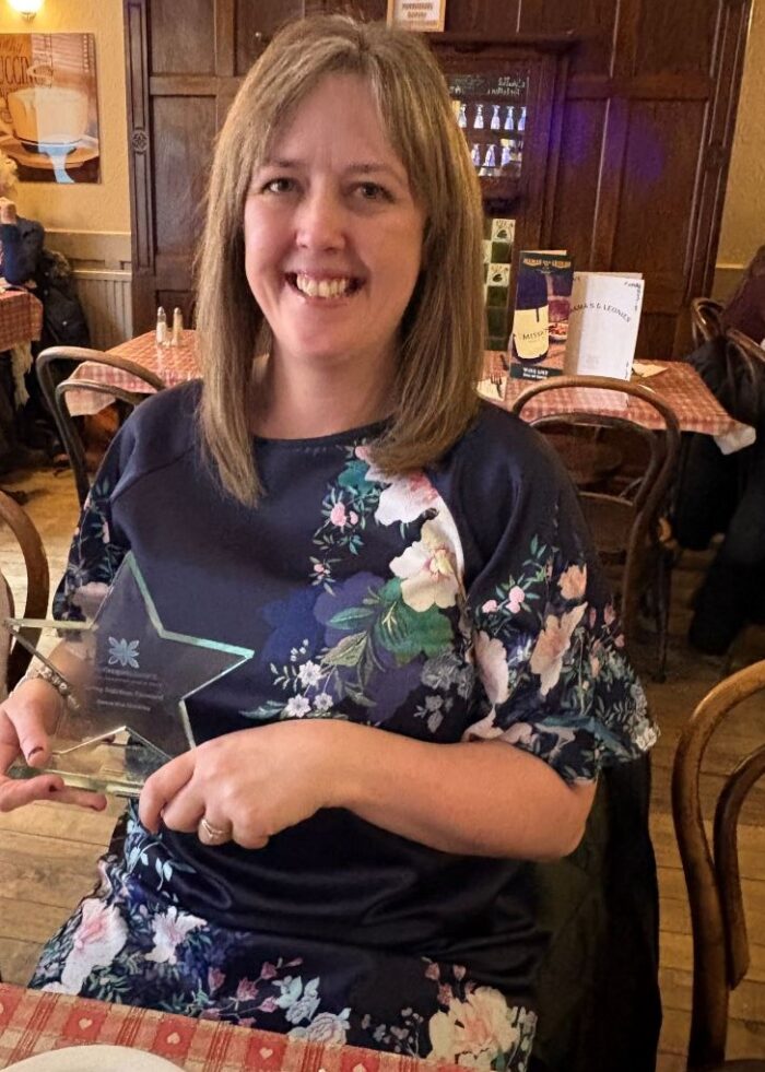 Sam with award